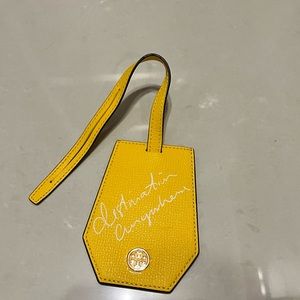 Brand new Tory Burch yellow luggage tag